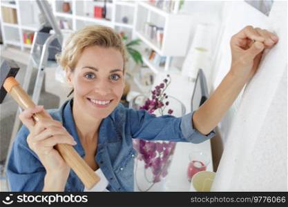woman with hammer at home