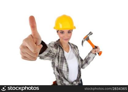 Woman with hammer giving thumbs up.