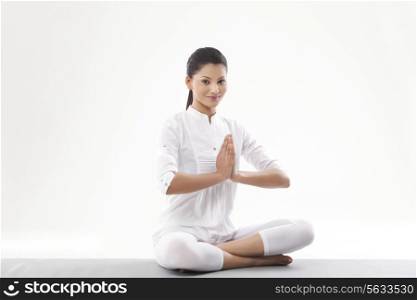 Woman with hands joint doing yoga