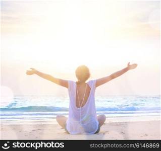 woman with hands up at sunrise beach. young caucasian woman embracing the sea at sunrise beach