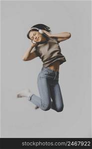 woman with headphones jumping air 2