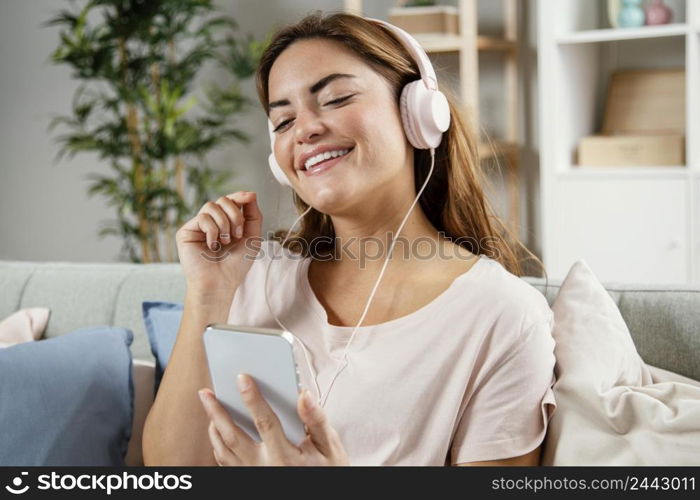 woman with headphones using mobile