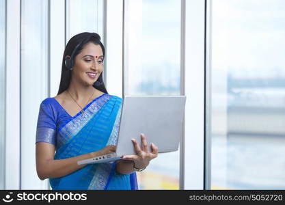 Woman with headset and laptop