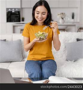 woman with headset eating while attending video call 2