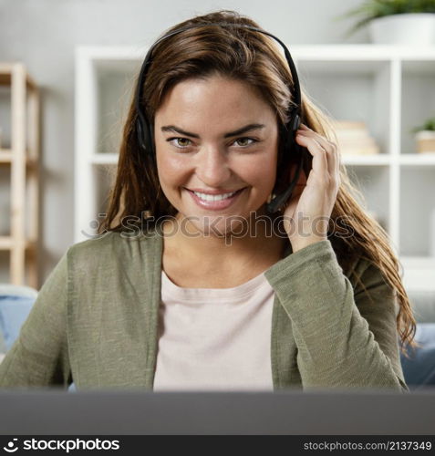 woman with headset having video call laptop