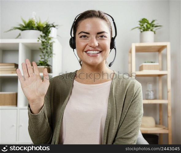 woman with headset waving