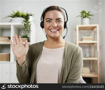 woman with headset waving