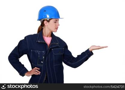 Woman with helmet gesturing on white background