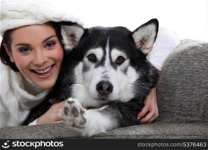 Woman with her dog on a sofa