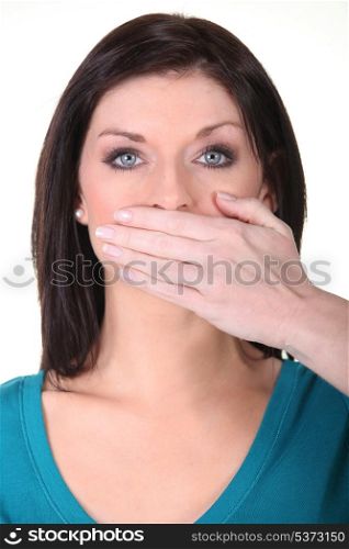 Woman with her hand over her mouth