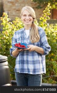 Woman with home-grown fruit