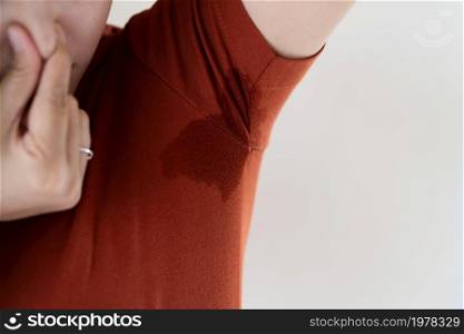 woman with hyperhidrosis sweating. Young Asia woman with sweat stain on her underarm clothes. Healthcare concept