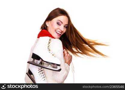 Woman with ice skates getting ready for ice skating, winter sport activity. Smiling cheerful girl with blowing hair wearing warm clothing on white. Happy woman with ice skates