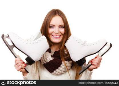 Woman with ice skates getting ready for ice skating, winter sport activity. Smiling girl wearing warm clothing on white studio shot