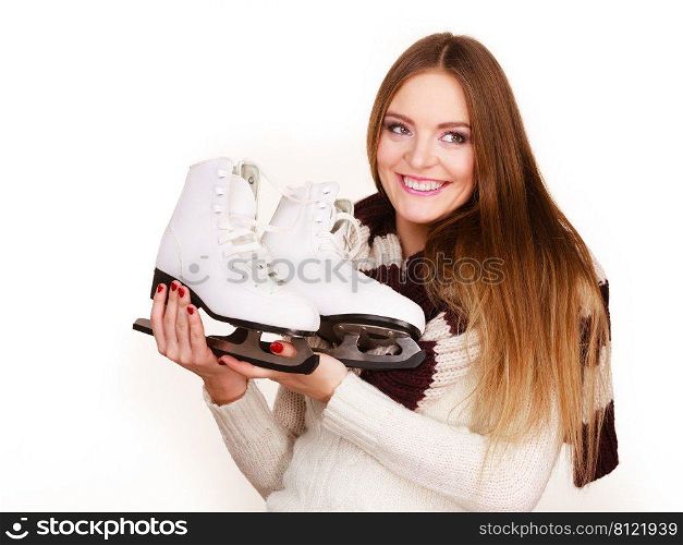 Woman with ice skates getting ready for ice skating, winter sport activity. Smiling girl wearing warm clothing on white studio shot . Woman with ice skates getting ready for ice skating