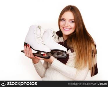 Woman with ice skates getting ready for ice skating, winter sport activity. Smiling girl wearing warm clothing on white studio shot . Woman with ice skates getting ready for ice skating