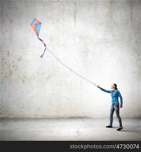 Woman with kite. Young woman in casual playing with kite