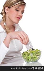 Woman with kiwi salad in bowl on white background