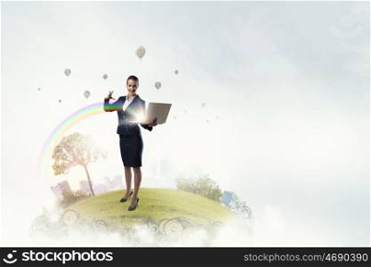 Woman with laptop in hands. Attractive businesswoman with laptop in hands doing magic