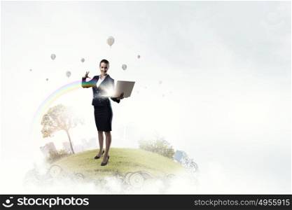 Woman with laptop in hands. Attractive businesswoman with laptop in hands doing magic
