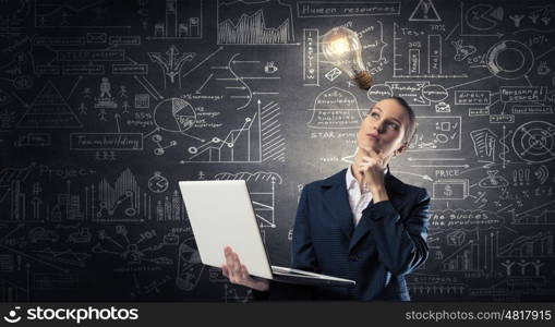 Woman with laptop in hands. Attractive businesswoman with laptop in hands thinking over her ideas