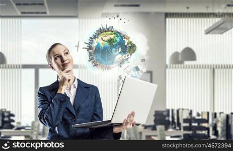 Woman with laptop in hands mixed media. Attractive businesswoman with laptop in hands in modern office interior. Elements of this image are furnished by NASA