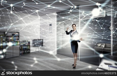 Woman with laptop in hands mixed media. Attractive businesswoman with laptop in hands in modern office interior