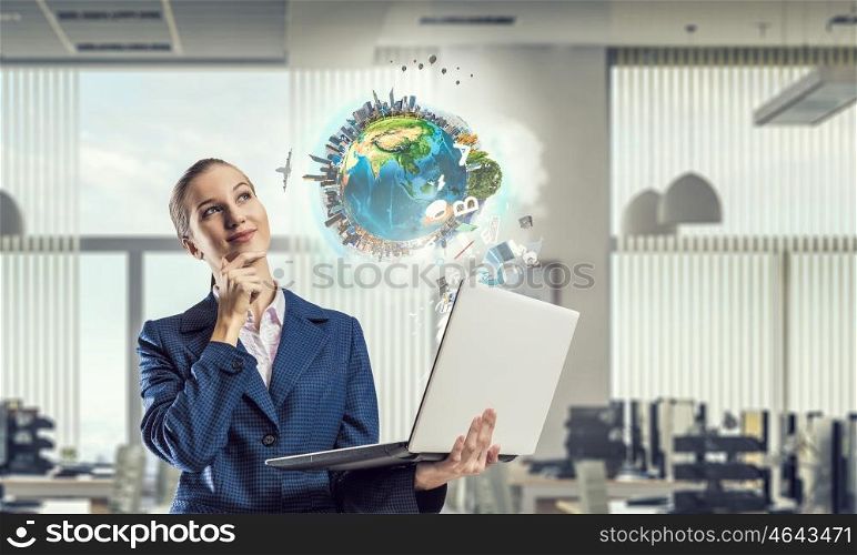 Woman with laptop in hands mixed media. Attractive businesswoman with laptop in hands in modern office interior. Elements of this image are furnished by NASA
