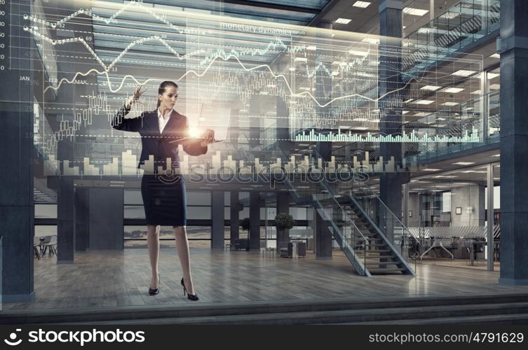 Woman with laptop in hands mixed media. Attractive businesswoman with laptop in hands in modern office interior