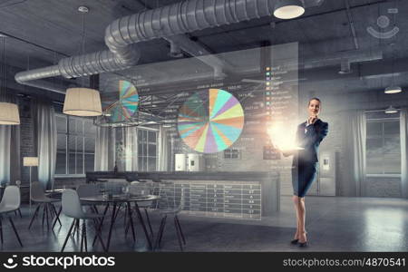 Woman with laptop in hands mixed media. Attractive businesswoman with laptop in hands in modern office interior