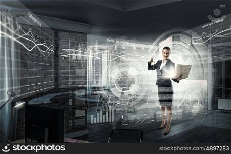 Woman with laptop in hands mixed media. Attractive businesswoman with laptop in hands in modern office interior