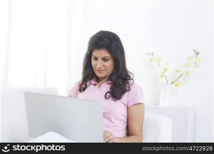 Woman with laptop listening to music