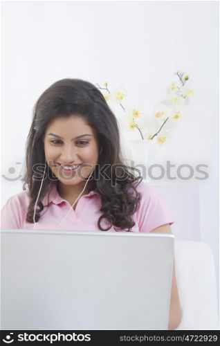 Woman with laptop listening to music