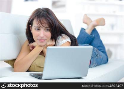 woman with laptop on sofa
