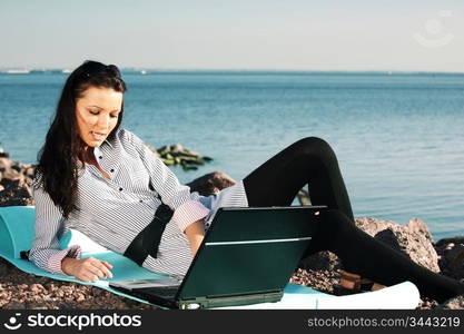 woman with laptop sea background