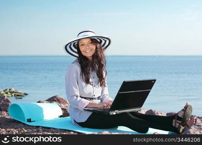 woman with laptop sea background