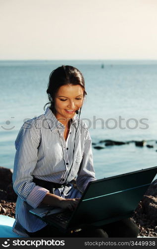 woman with laptop sea background