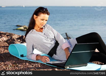 woman with laptop sea background