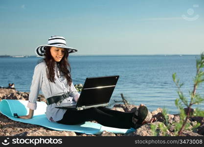 woman with laptop sea background