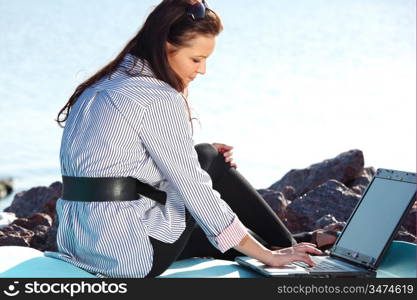 woman with laptop sea background