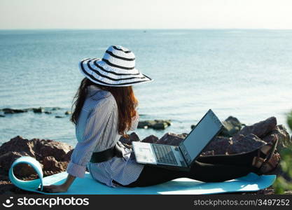 woman with laptop sea background