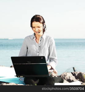 woman with laptop sea background