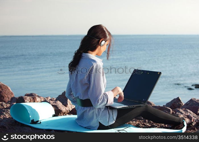 woman with laptop sea background