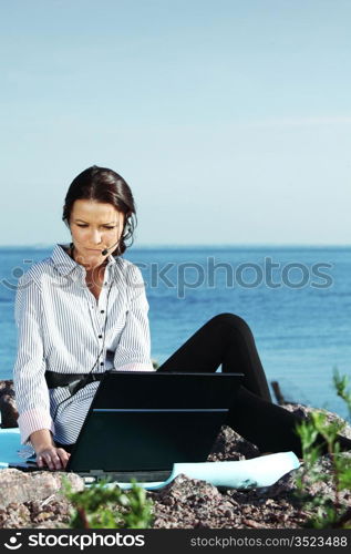 woman with laptop sea background