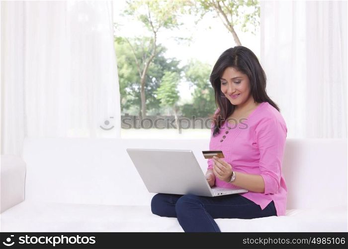 Woman with laptop shopping online