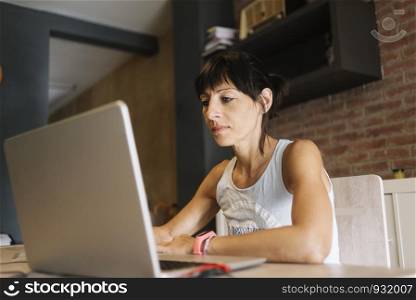 Woman with laptop working at home.. Marta Rodriguez.jpg