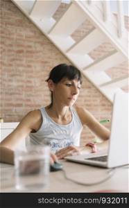 Woman with laptop working at home. Marta Rodriguez.jpg