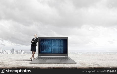 Woman with laptop. Young pretty businesswoman leaning on big laptop