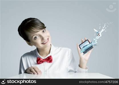 Woman with laptop. Young woman holding miniature of laptop in hand