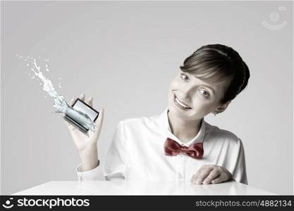 Woman with laptop. Young woman holding miniature of laptop in hand